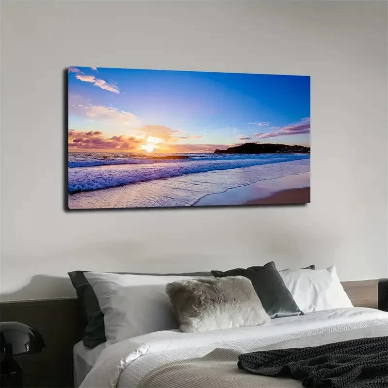 Beach sunset scene on a wall above a bed