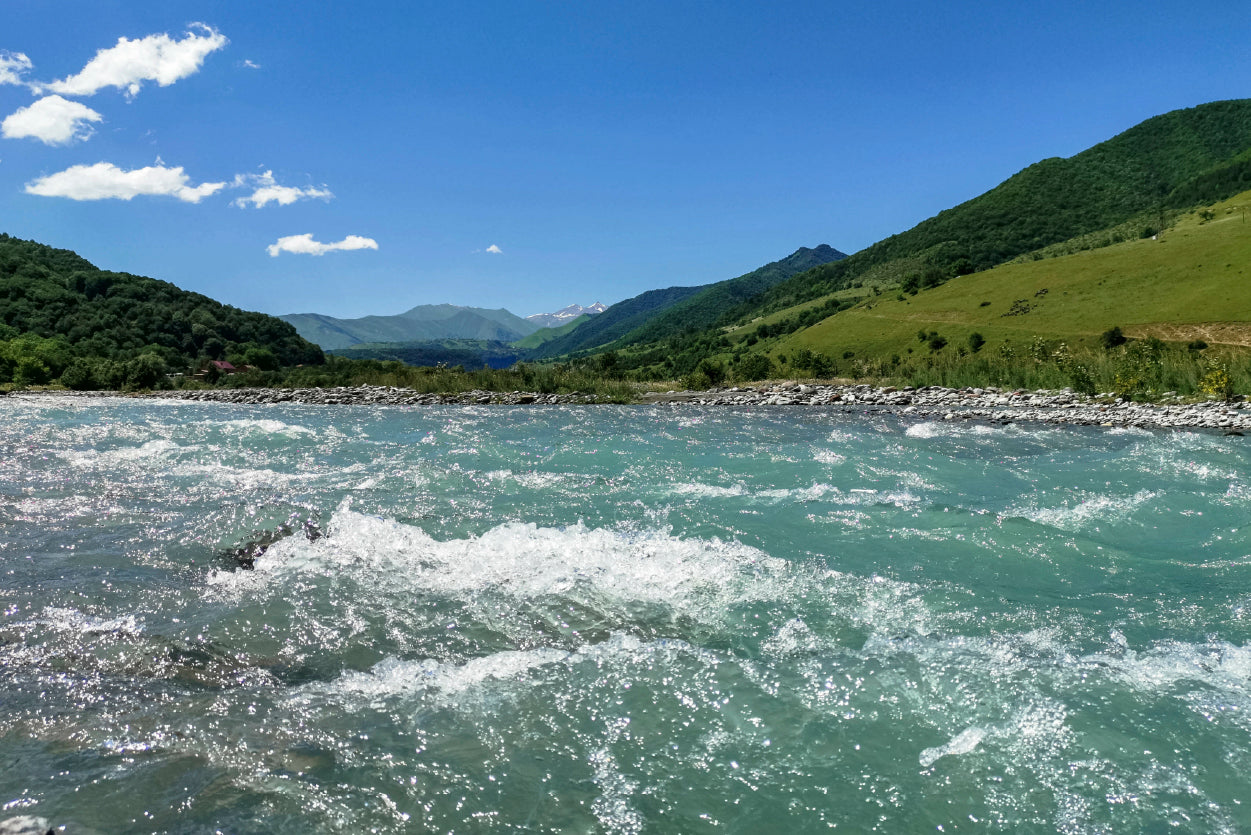 A River Flowing Through Green Hills with Mountains Home Decor Premium Quality Poster Print Choose Your Sizes