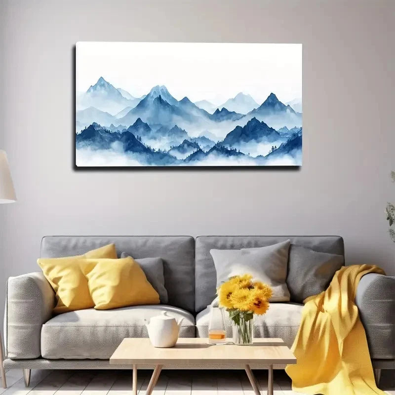 Living room with a gray sofa, yellow pillows, and a mountain painting on the wall.