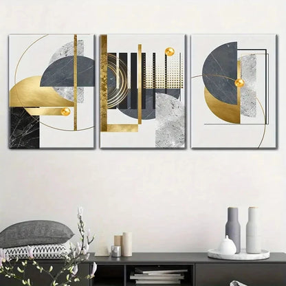 Set of three abstract art pieces with gold and black elements on a wall above a console table.