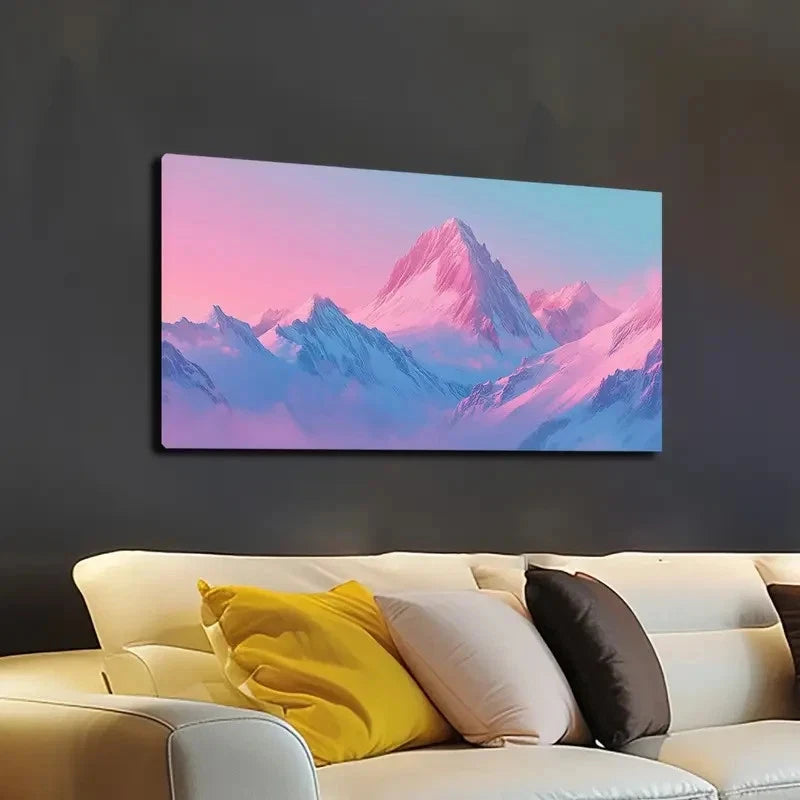 Canvas print of a mountain landscape with pink and blue hues above a beige sofa.