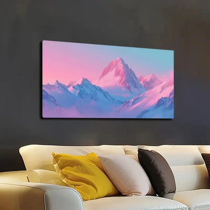 Canvas print of a mountain landscape with pink and blue hues above a beige sofa.