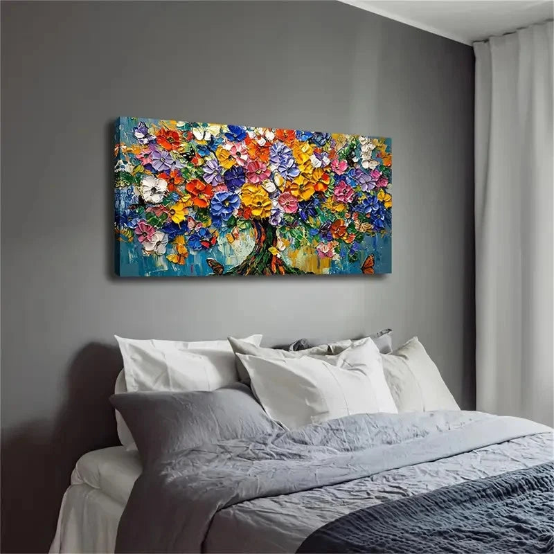 Colorful floral painting on a gray wall above a bed with gray bedding.