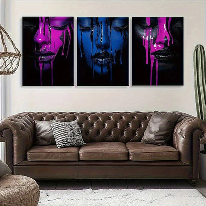 Three abstract paintings of faces with colorful liquids on a wall above a brown leather sofa.