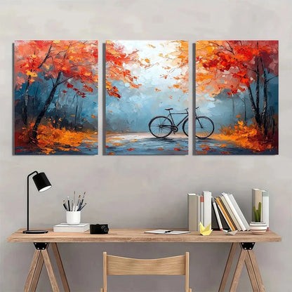 Three-panel abstract painting of a bicycle in an autumn setting above a desk.