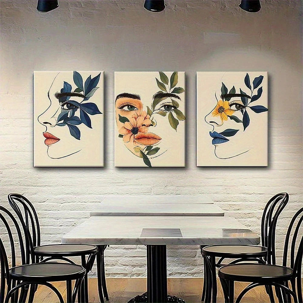 Three abstract art pieces on a wall above a dining table with chairs.