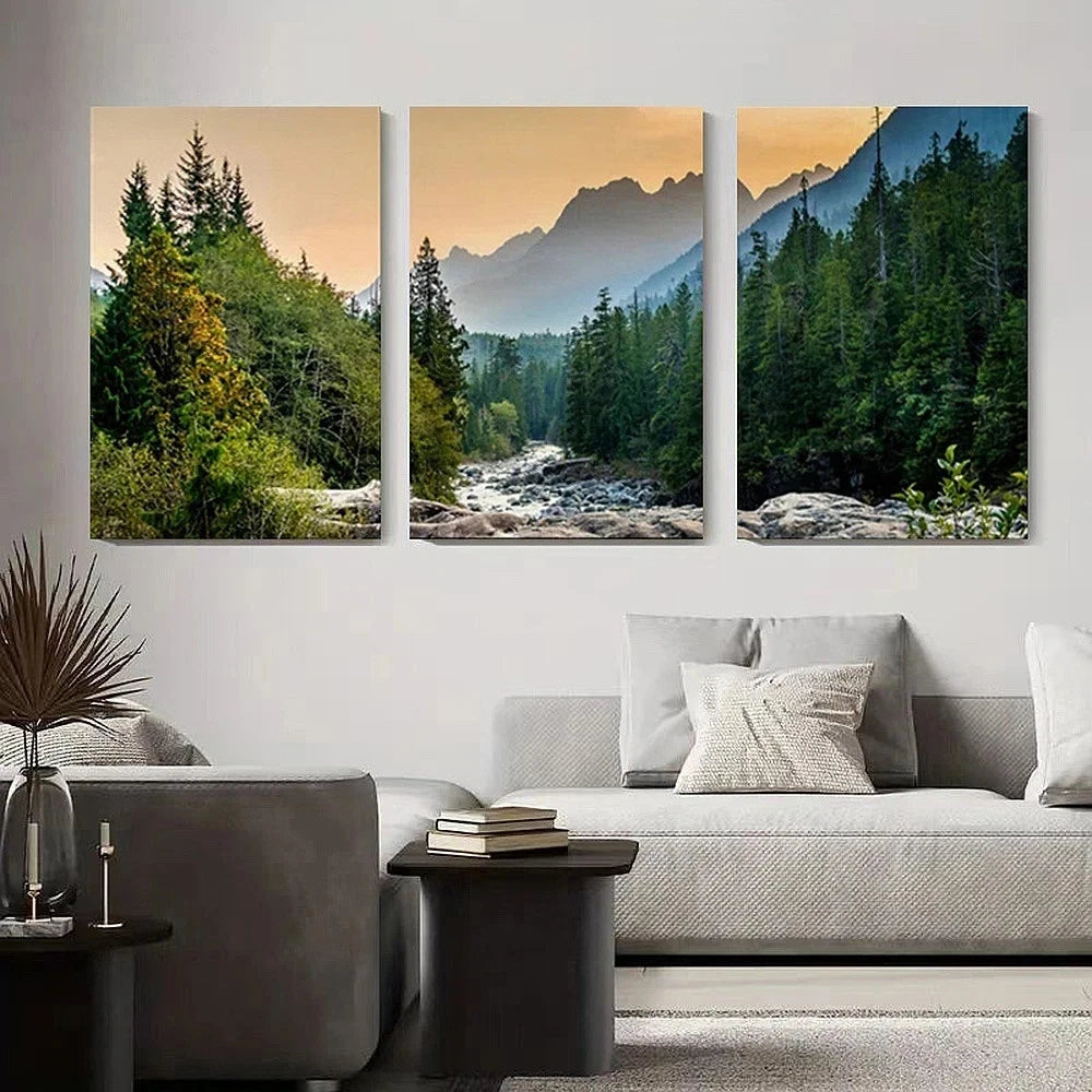 Three landscape paintings of mountains and forests above a sofa in a living room.