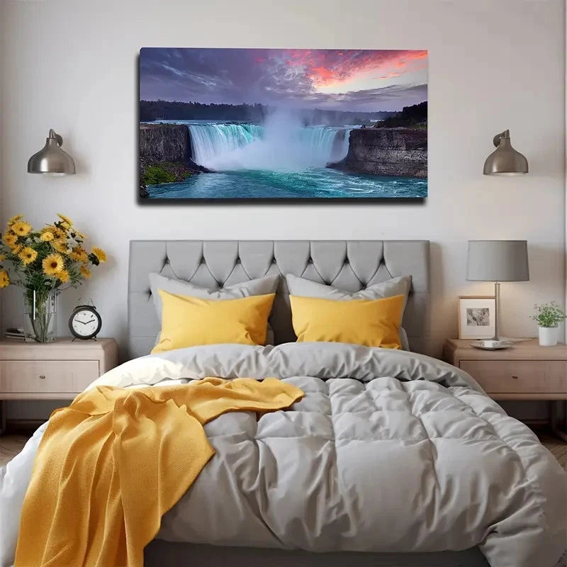 Bedroom with a large bed, yellow pillows, and a wall canvas of a waterfall.
