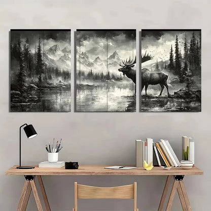 Three-panel wall art of a moose in a forest setting above a wooden desk with books and a lamp.