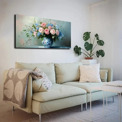 Living room with a beige sofa, decorative pillows, and a wall art piece of flowers in a vase.