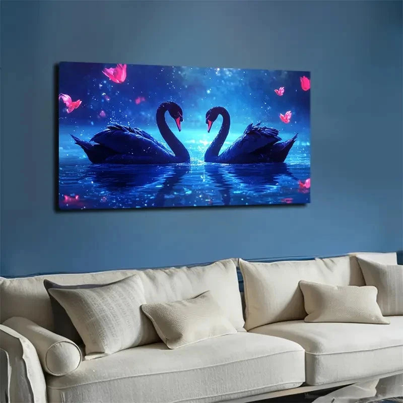 Canvas print of two swans on a blue background above a beige sofa.