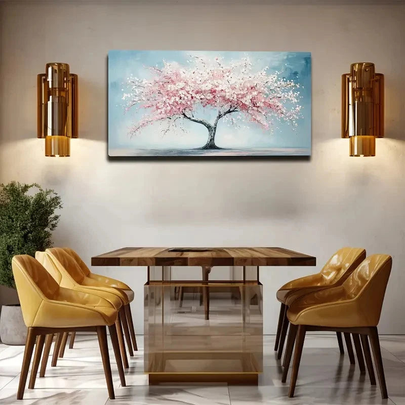 Dining room with wooden table and chairs, wall art of a cherry blossom tree, and wall sconces.