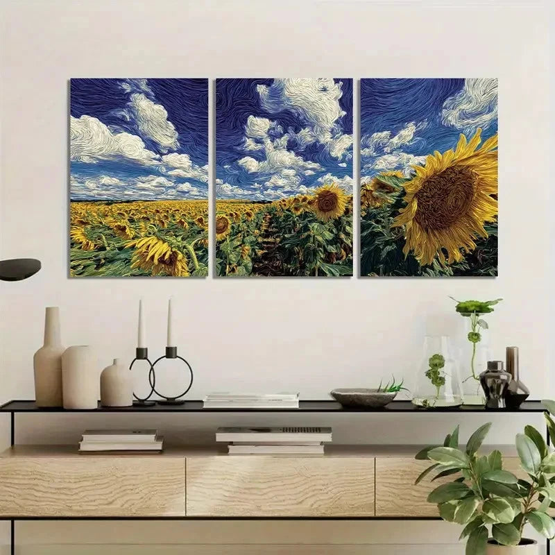 Three-panel artwork of sunflowers and a blue sky above, displayed on a wall above a wooden cabinet.
