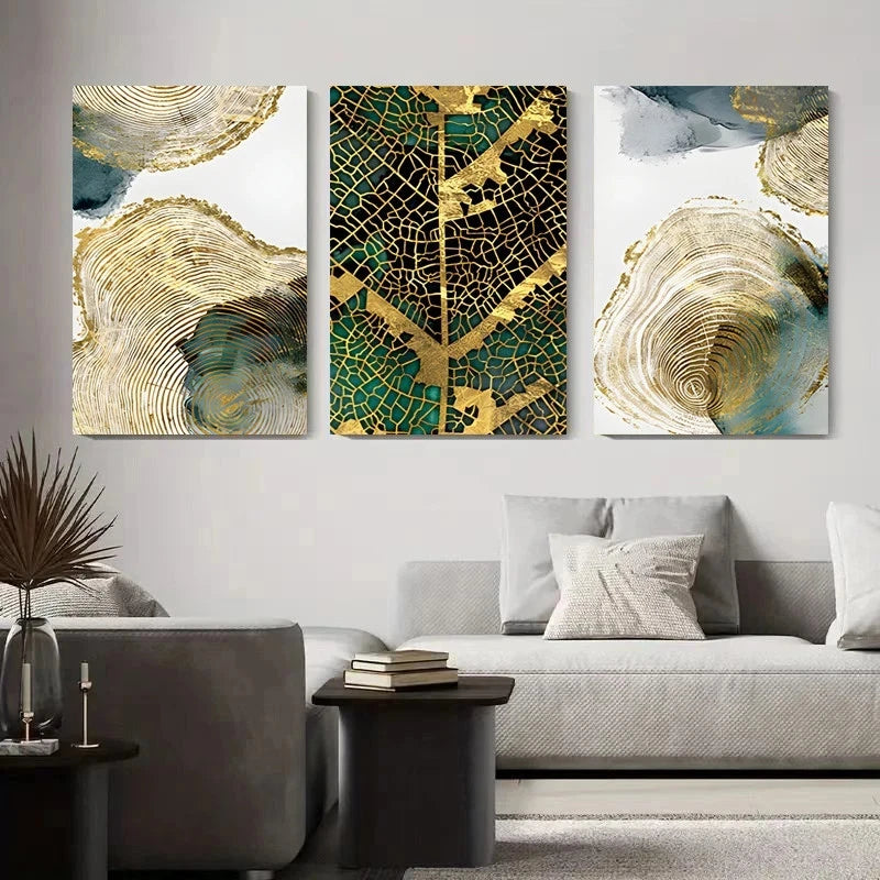 Three abstract art pieces on a wall above a sofa in a living room.