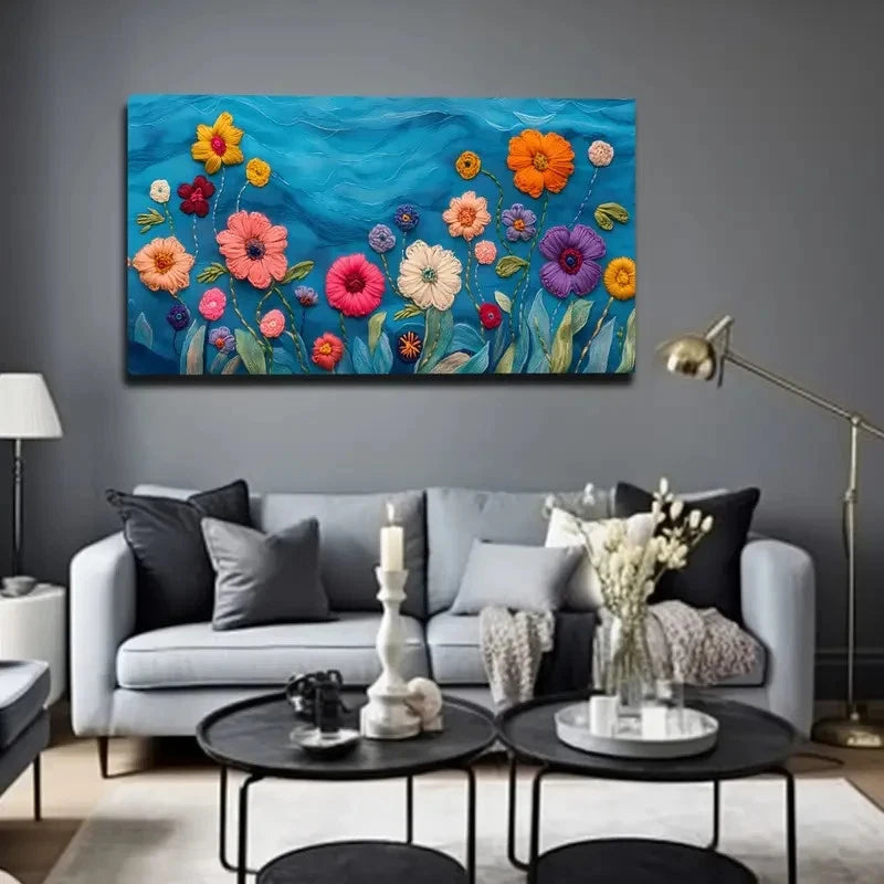 Living room with a colorful floral painting on the wall above a gray sofa.