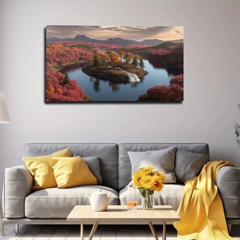 Landscape painting of a river and island with fall foliage above a gray sofa with yellow pillows.