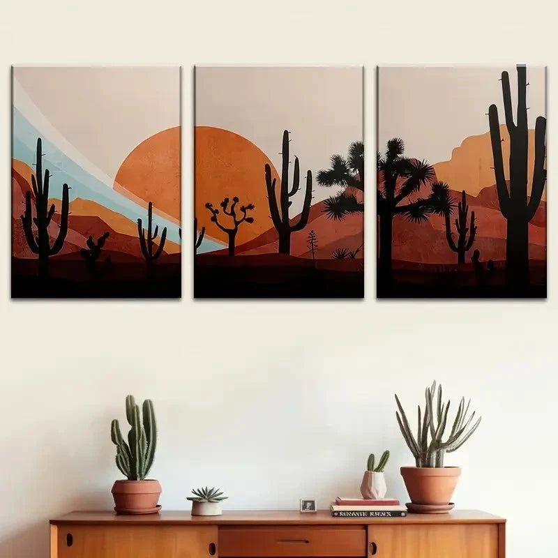 Three desert-themed wall art pieces above a wooden cabinet with potted plants.