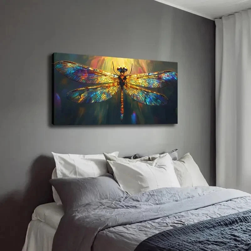 Colorful dragonfly painting on a wall above a bed with gray bedding.