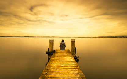 Man Sitting on Wooden Pier Over Lake at Sunset Photograph Print 100% Australian Made